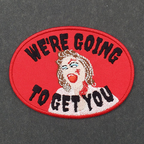 red twill oval embroidered patch of Linda from Evil Dead with message "WE'RE GOING TO GET YOU"