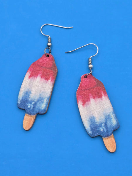 wooden dangle earrings laser cut and printed with images of red white and blue popsickles