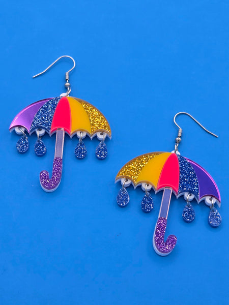 yellow, neon pink, blue, and purple multicolored sparkly umbrella dangle earrings with attached sparkly blue raindrop charms