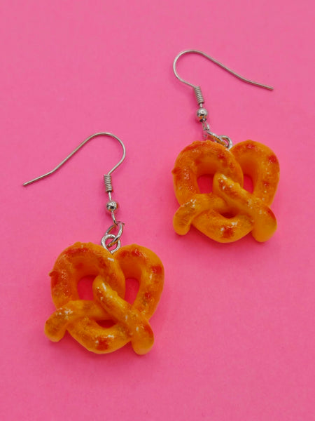 Acrylic dangle earrings with large golden pretzel charms