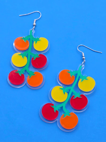 clear acrylic dangle earrings with printed image of bright orange, yellow, red tomatoes on green vine