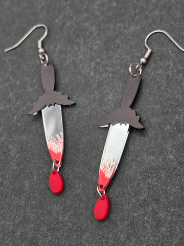 Acrylic dangle earrings in the shape of bat-shaped handled mirrored dagger with blood drop