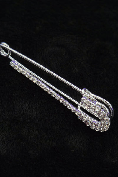 silver metal safety pin with clear "rhinestone" jewels, showing side view