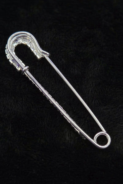 silver metal safety pin with clear "rhinestone" jewels, showing back of pin