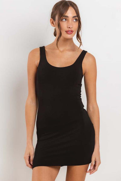 Model wearing brushed fiber knit tank mini dress with double lining and rounded scoop neckline. Shown from front