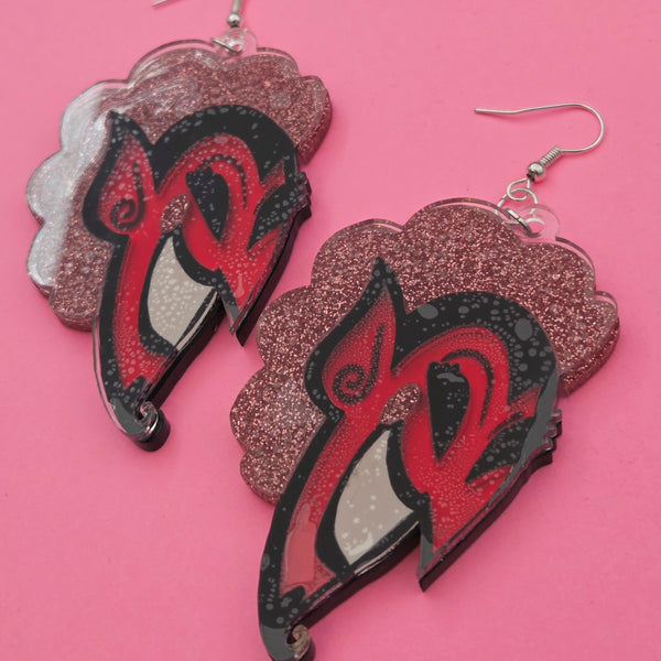 back view of laser cut acrylic dangle earrings with pair of charms in the shape of the face of HIM from Powerpuff Girls with glittery pink hair and cheeks