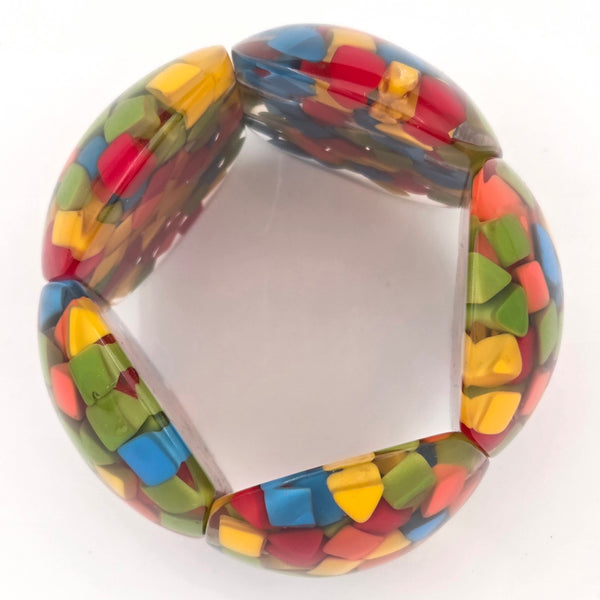 Multicolored shapes in resin bracelet on a white background