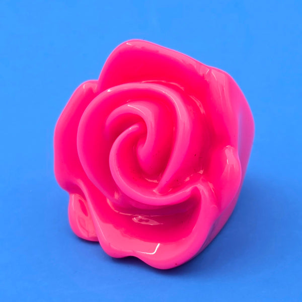 neon pink resin rose ring on blue background
