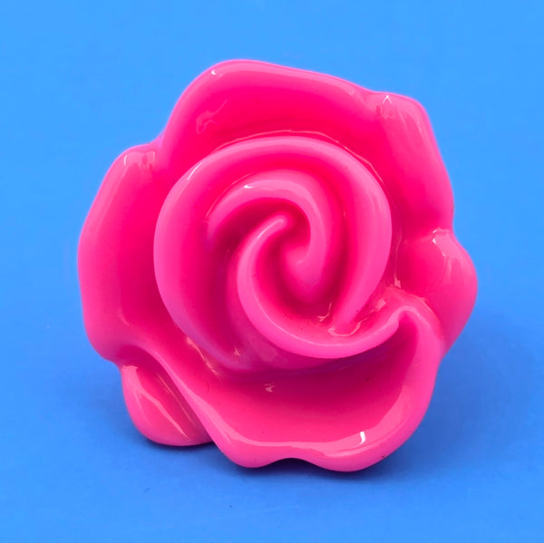 neon pink resin rose ring on blue background