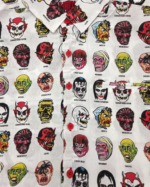 close up of white cotton short sleeve button up shirt with all over colorful print of cartoon monster masks