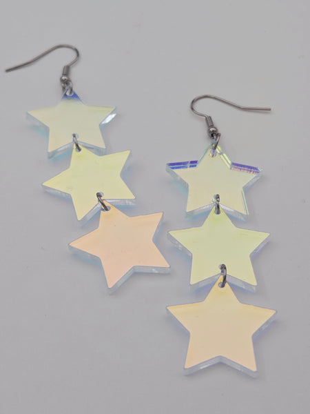 flash finish clear acrylic star-shaped earrings on a gray background