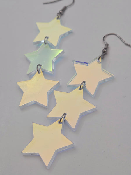 flash finish clear acrylic star-shaped earrings on a gray background
