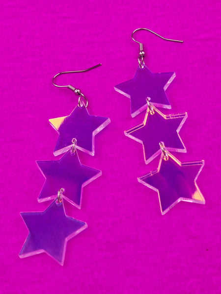 flash finish clear acrylic star-shaped earrings on a purple background
