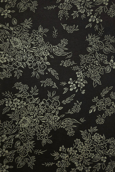 Black fabric with a repeating putty grey floral and leaf pattern.