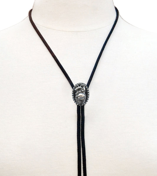Silver metal anatomical heart charm bolo tie on black rayon cord with silver end tips. Shown on dress form in close up