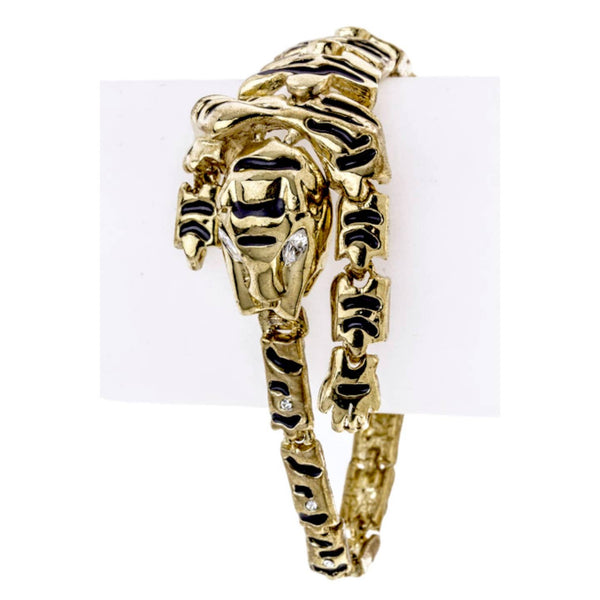 Gold metal articulated tiger-shaped wrap bracelet with enameled black stripes and clear jeweled eyes & tail detail. Clasp meets at end of tail to mouth. Shown from the front