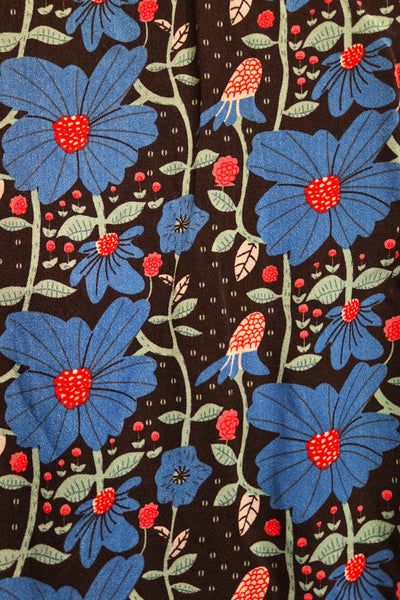 fabric swatch close up of allover royal blue, red, white, and green floral vertical climbing vine print