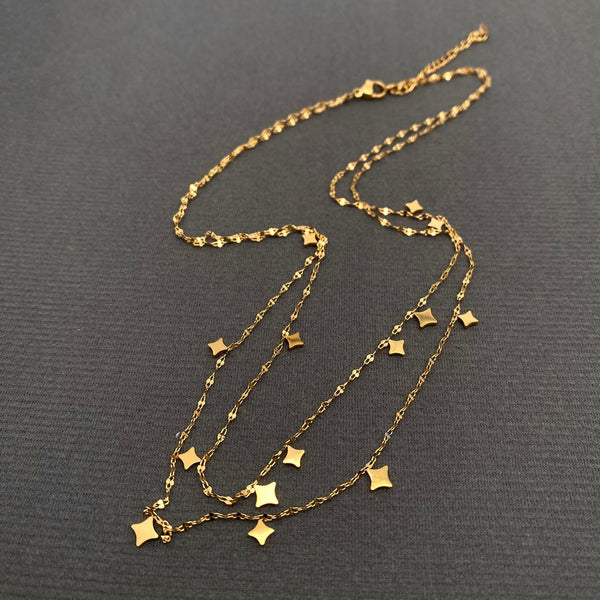 double layer 18k gold plated stainless steel lip chain necklace with stylized star charms. Shown flat