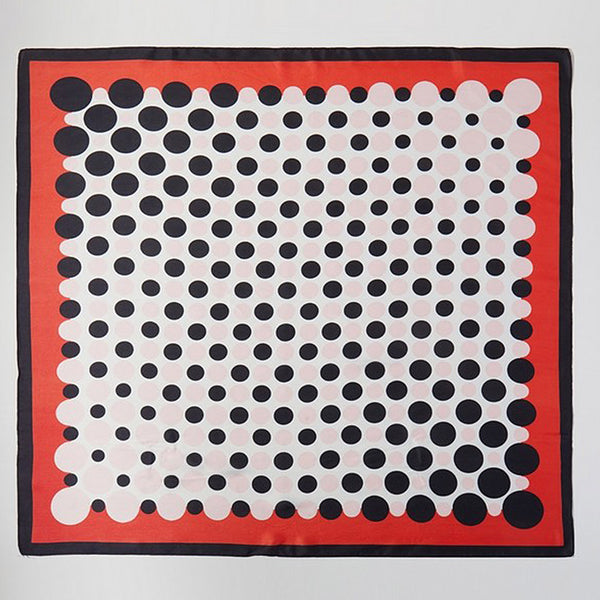 square silk scarf with white background and black & very light pink dot center and red and black border. Shown flat