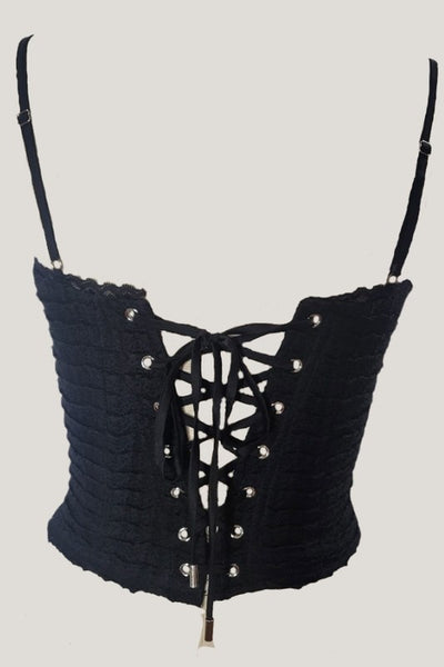 Black waffle knit bustier top with adjustable spaghetti straps and black lace trim at sweetheart neckline. Shown from the back to display corset-style lace up back with silver metal grommets and black ribbon tie