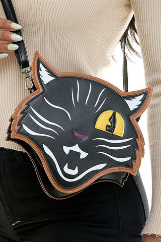 winking black cat-shaped cross-body purse shown worn by a model wearing a white sweater