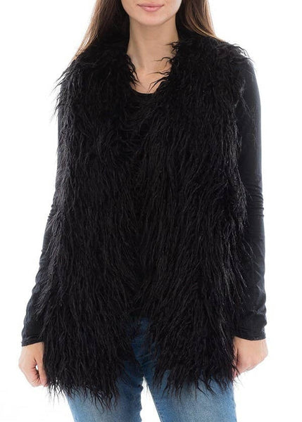 Black shaggy faux fur vest worn by a person on a white background. Shown from front