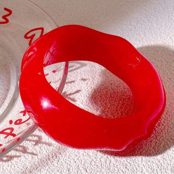 shiny slightly irregular wavy-shaped resin bangle in a yummy shade of candy apple red