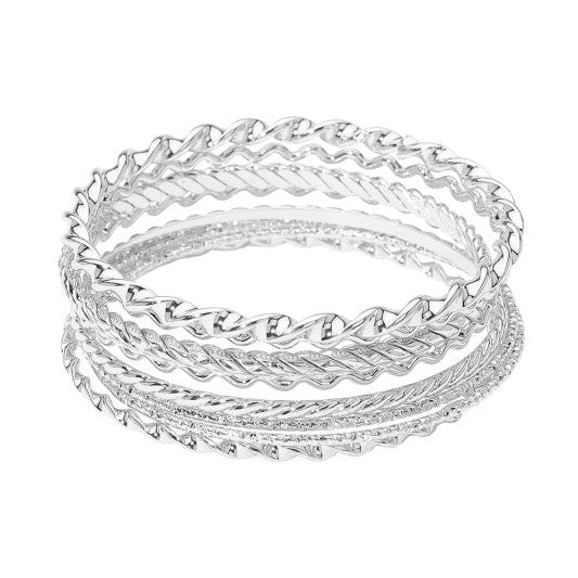 set of eight various textured wavy and twisted silver metal bangles shown stacked