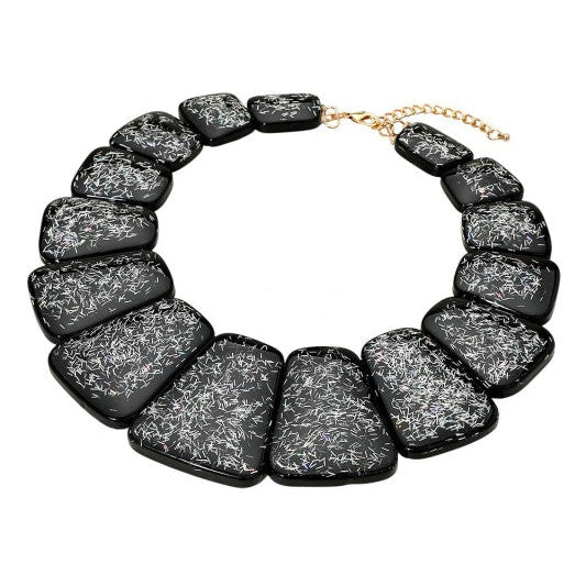 bib necklace made of segments of flat black resin rounded trapezoid shapes with iridescent bar glitter