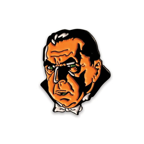 stylized rendering of Bela Lugosi as Dracula as a black & neon orange and green enameled pin with both shiny and matte finish