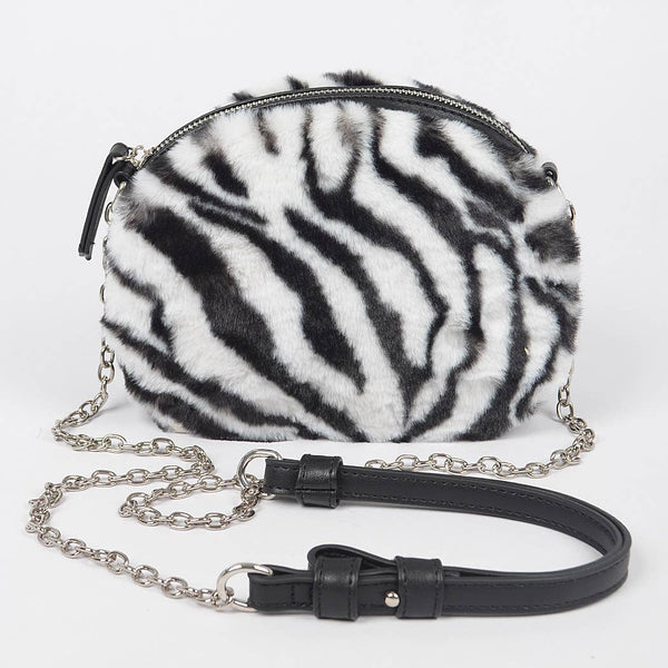 Zebra print black and white faux fur handbag with a chain strap and faux black leather shoulder piece on a white background