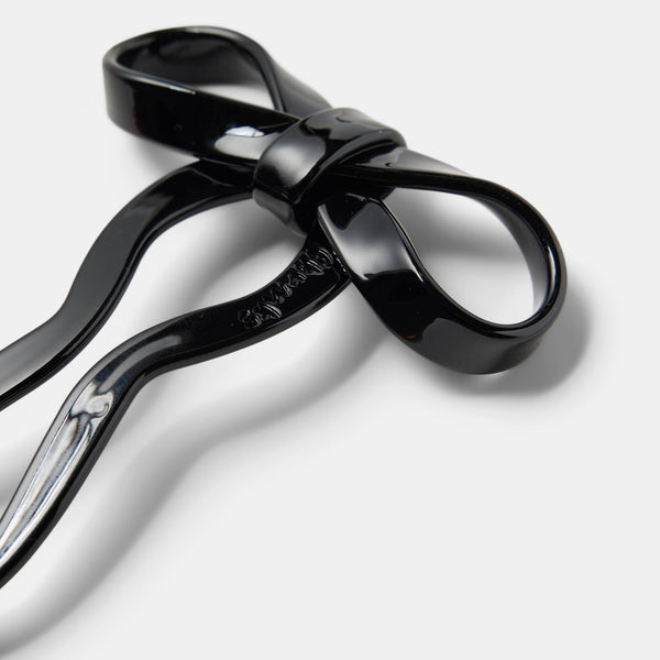 5 1/2" black acetate bow shaped hairpin. Shown flat in close up