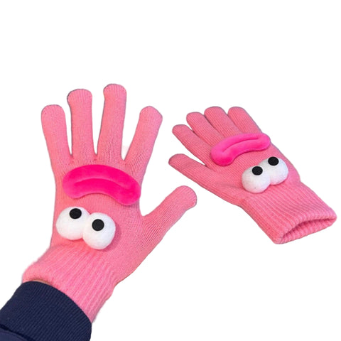 pair of pink knit gloves with pompom and hot pink velvet appliques to form cartoon smiling faces on the back of each hand. Shown worn and flat