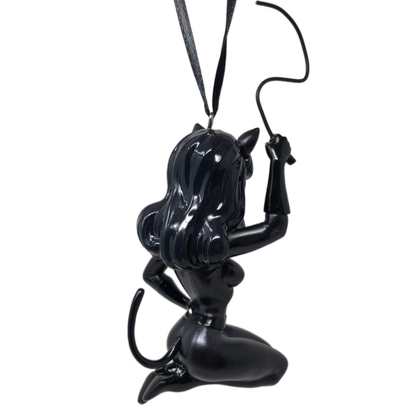 “Kitten with a Whip" painted resin ornament featuring Bettie Page in black catsuit with ears and wire whip. Shown from back