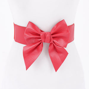 bright red faux leather waist belt with large asymmetrical bow