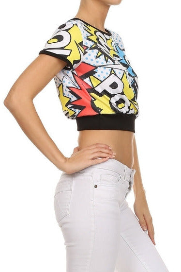 short sleeve relaxed fit crop in a punchy comic book pop art style white, blue, red, yellow, and black "POW!" print, with black ribbed knit arm holes, neck, and bottom hem, shown side view on a model