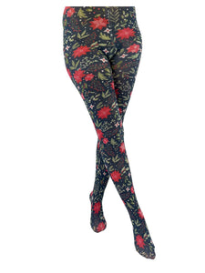 A model wearing opaque tights with a poinsettia, holly, and snowberry pattern on a forest green background. Seen from front 