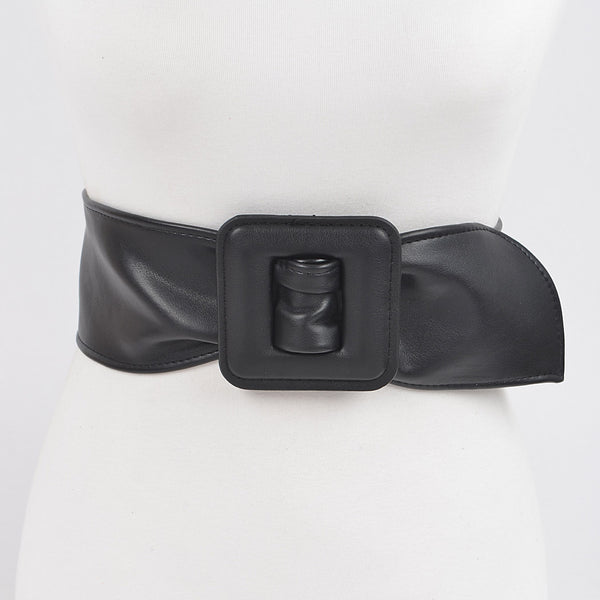 Black matte finish faux leather belt with a large square self buckle on dress form on a white background