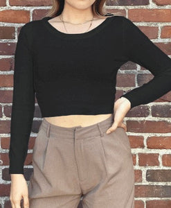 long sleeve black sweater featuring a wide round neckline and cropped length. shown on a model.