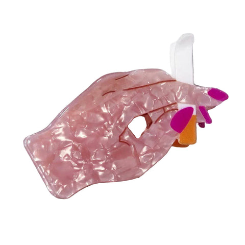 Marbled acetate claw style hair clip in the shape of hand with magenta painted fingernails holding a cigarette