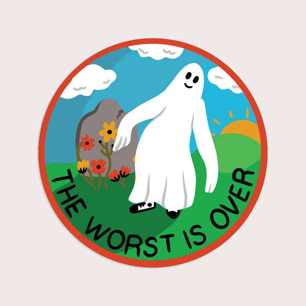 Round die-cut vinyl sticker with illustration with a ghost, flowers, and 'The Worst is Over' text on a light pink background
