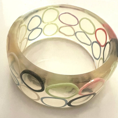 transparent resin bangle with two inlaid rows of multicolored rubber bands