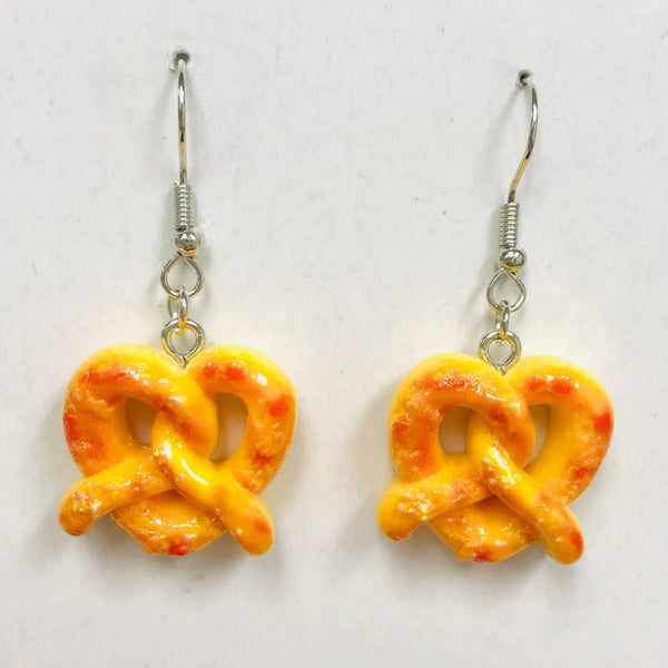 Acrylic dangle earrings with large golden pretzel charms