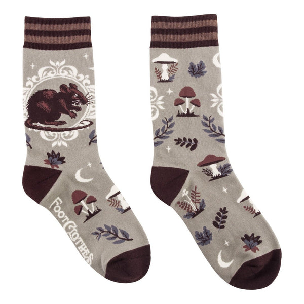 Pair of socks with nature-themed design featuring a rat, mushrooms, and leaves on a gray background with striped brown cuffs and solid brown heels and toes. Shown flat