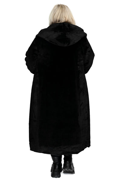 model wearing a black faux fur coat with wide lapel and oversized faux fur lined hood. Coat has double black plastic button closure and side seam pockets. Shown from back with hood down