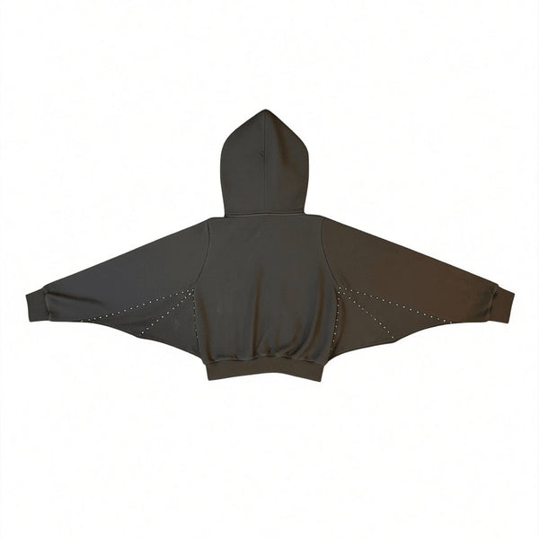French terry zip up cropped hoodie with double zipper pull, oversized drawstring hood, kangaroo pockets, and scalloped batwing style detail under each arm with silver metal stud detail. Shown zipped from back