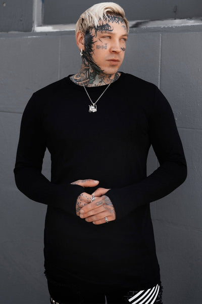 model wearing black long sleeve crew neck shirt with thumb holes. Shown from front