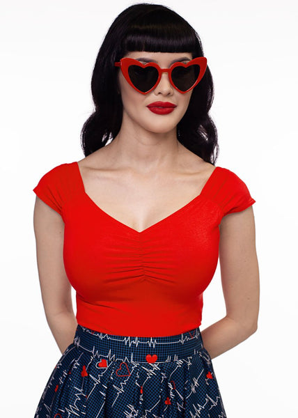 fitted bright red top in soft brushed fiber stretch knit cap sleeves sweetheart neckline, shown on model wearing it tucked into high waist skirt