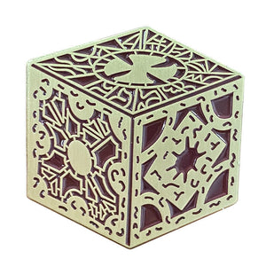 Brown enameled gold metal pin depicting the square puzzle box from Hellraiser