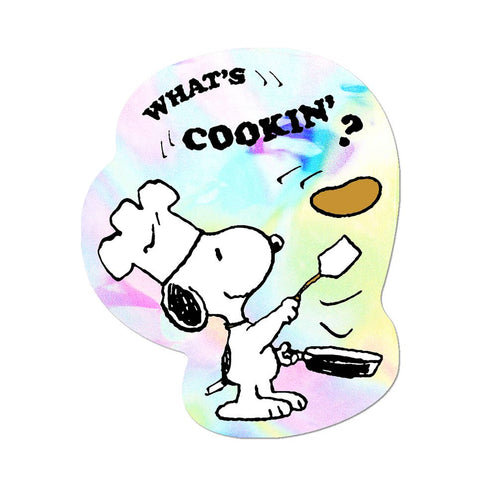 Holographic sticker of Snoopy holding a spatula and flipping a pancake with 'What's Cookin?'' text in black